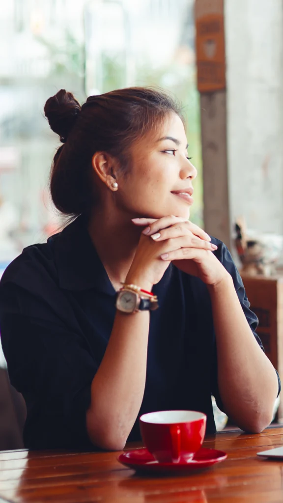 Career coach relaxing at a coffee shop because she's not worried about where to get coaching clients with her lead generation for coaches strategy by Iterateology by following the 3 simple steps to growing her business.