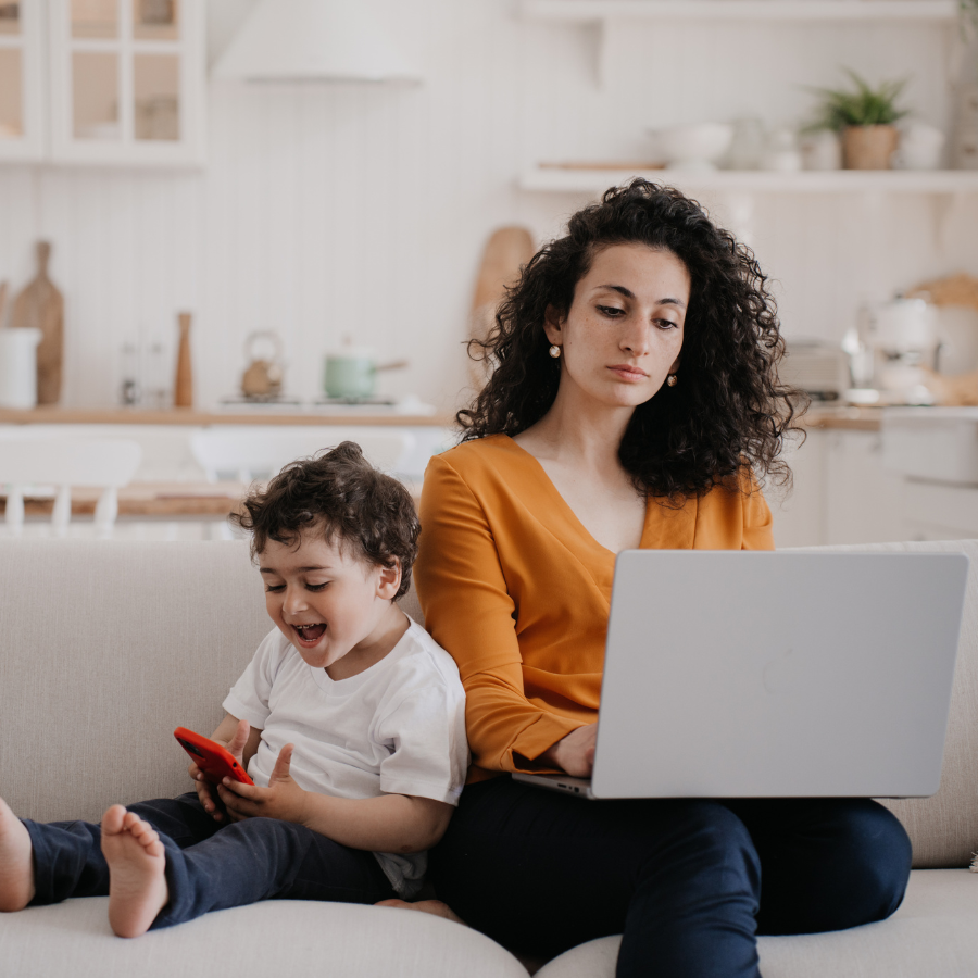 Coaching CEO spending time on marketing that isn't working while her son plays on a smartphone beside her.